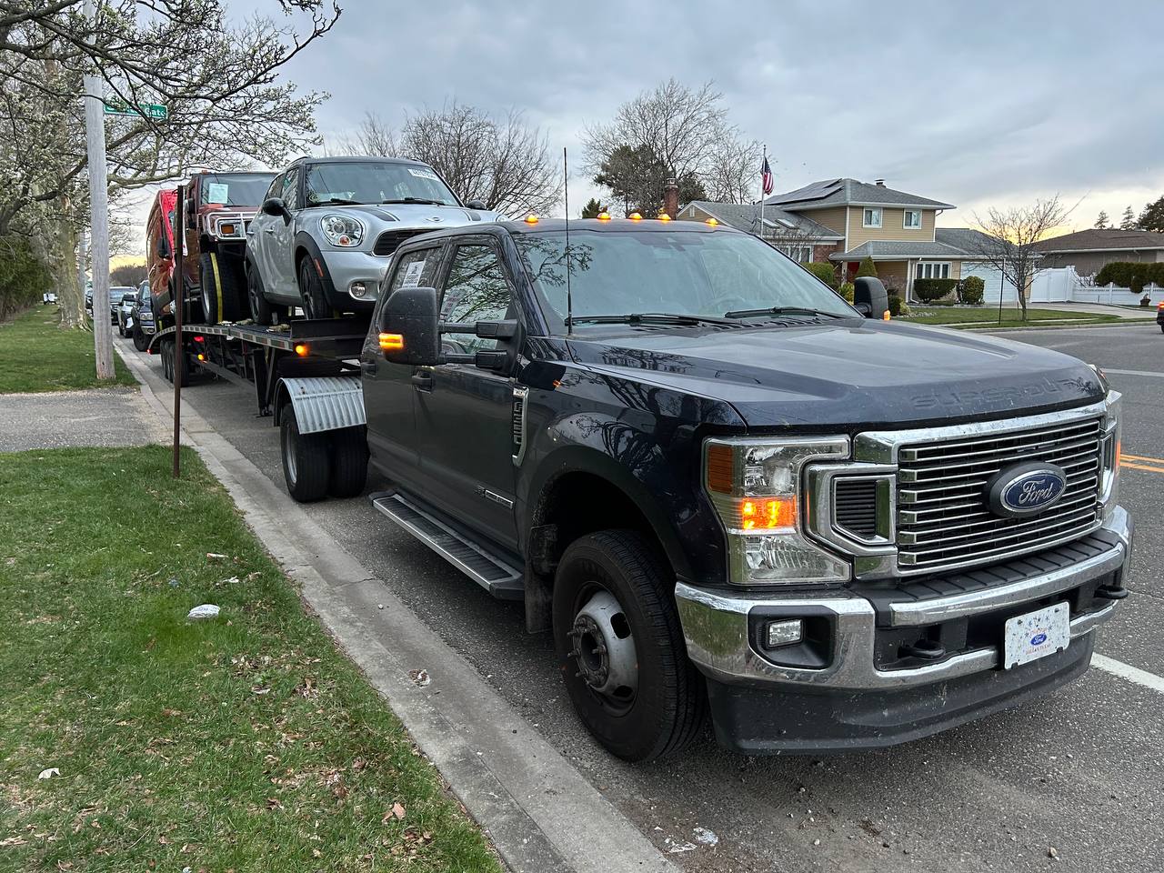 VS Performance LLC Ford Super Duty truck with car hauler trailer during evening operations